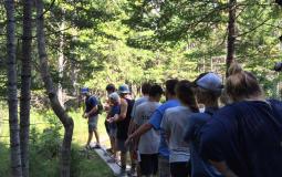 Students in the Earth Service Corps at the Upper Main Line YMCA explore a cedar swamp in Maine 