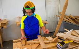 Child building during woodshop free family event at the Upper Main Line YMCA.