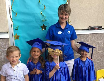 Natalya Kuzovleva, a Montessori preschool program teacher, poses with children on their graduation from the Montessori program at the West Chester Area YMCA
