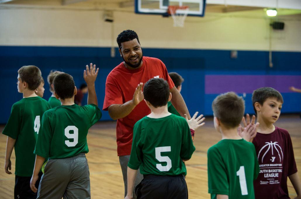 Youth sports - Teams show sportsmanship with high-fives after their youth basketball game at the Jennersville YMCA in Chester County, PA