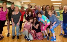 Group of YMCA members posing in a group exercise studio at the Kennett Area YMCA.