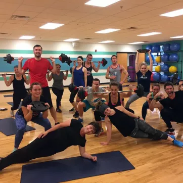 YMCA Members share silly poses after a group exercise class lifting weights, doing yoga poses and more.