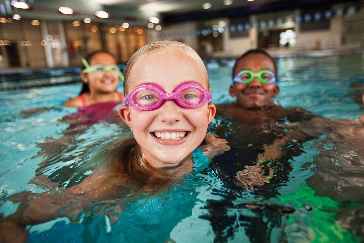 A child enjoys the indoor swimming pool at the YMCA in Chester County while learning to swim at YMCA Swimming lessons.