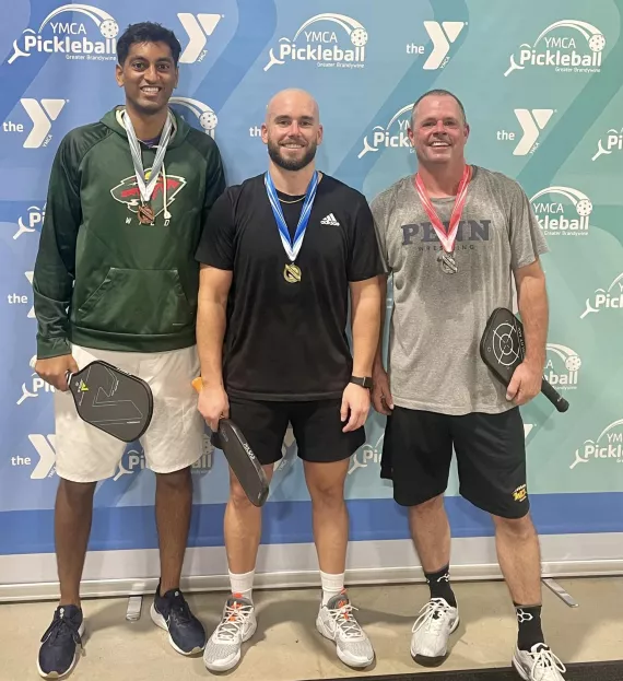 Pickleball Center tournament winners pose for a photo with their medals