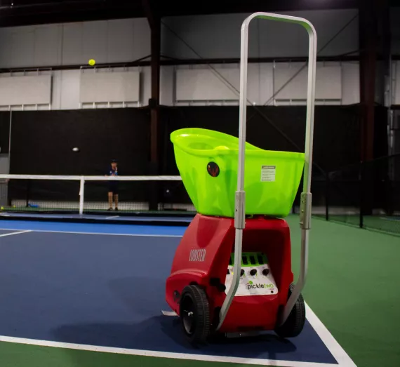 Lobster ball machine serves a pickleball to a player at the YMCA Pickleball Center