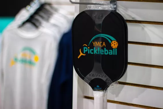 YMCA Pickleball paddle hangs in the Pro Shop at Pickleball Center