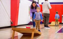 Mother and son playing cornhole during a family fun activity at the YMCA of Greater Brandywine.