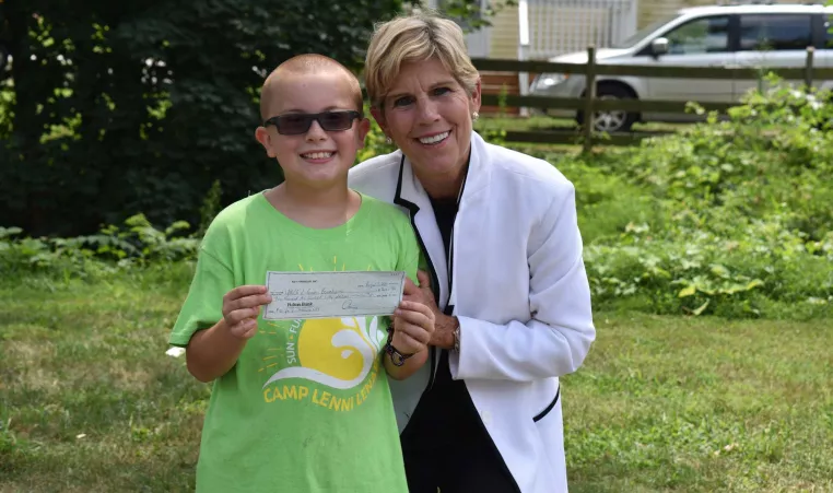 Owen Jones, who is running a #10for10 campaign raising funds for summer camp at the YMCA meets Patti Brennan from Key Financial who donates a matching gift to his campaign.