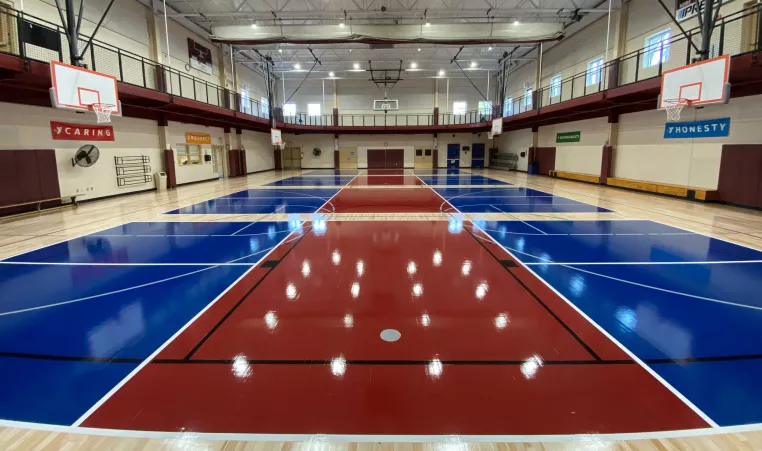 Indoor pickleball courts in red and blue are shown at the gymnasium at the West Chester Area YMCA in West Chester PA