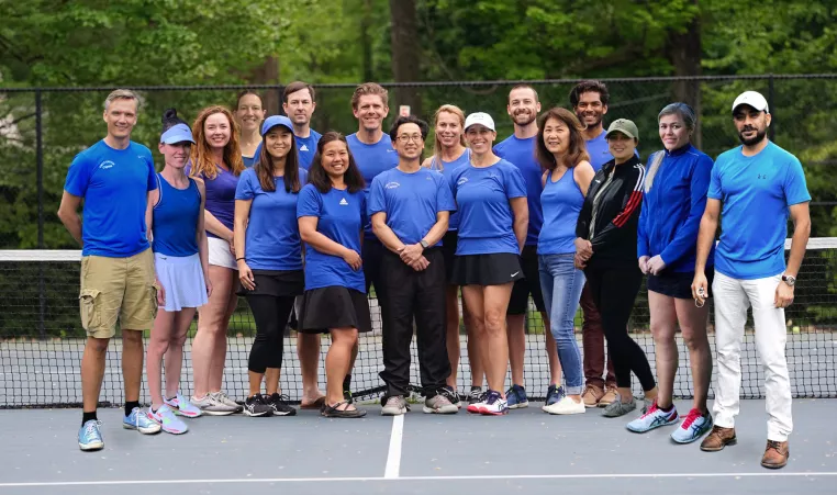 The Upper Main Line YMCA tennis 7.0 adult performance tennis team poses for a team photo on the tennis courts at the Berwyn location. 